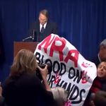 A protester interrupting the NRA press conference